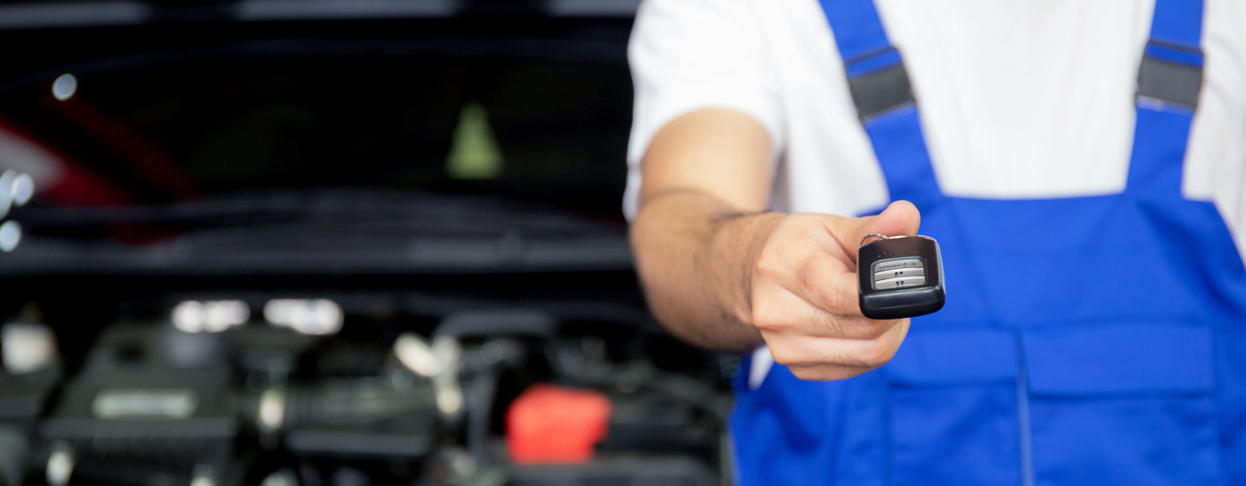 an image of a technician handing car keys towards the camera