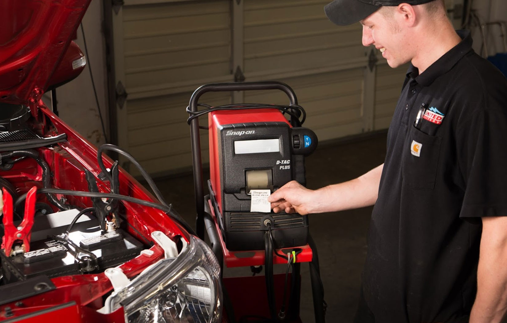 A United Battery technician performing diagnostics on a battery.