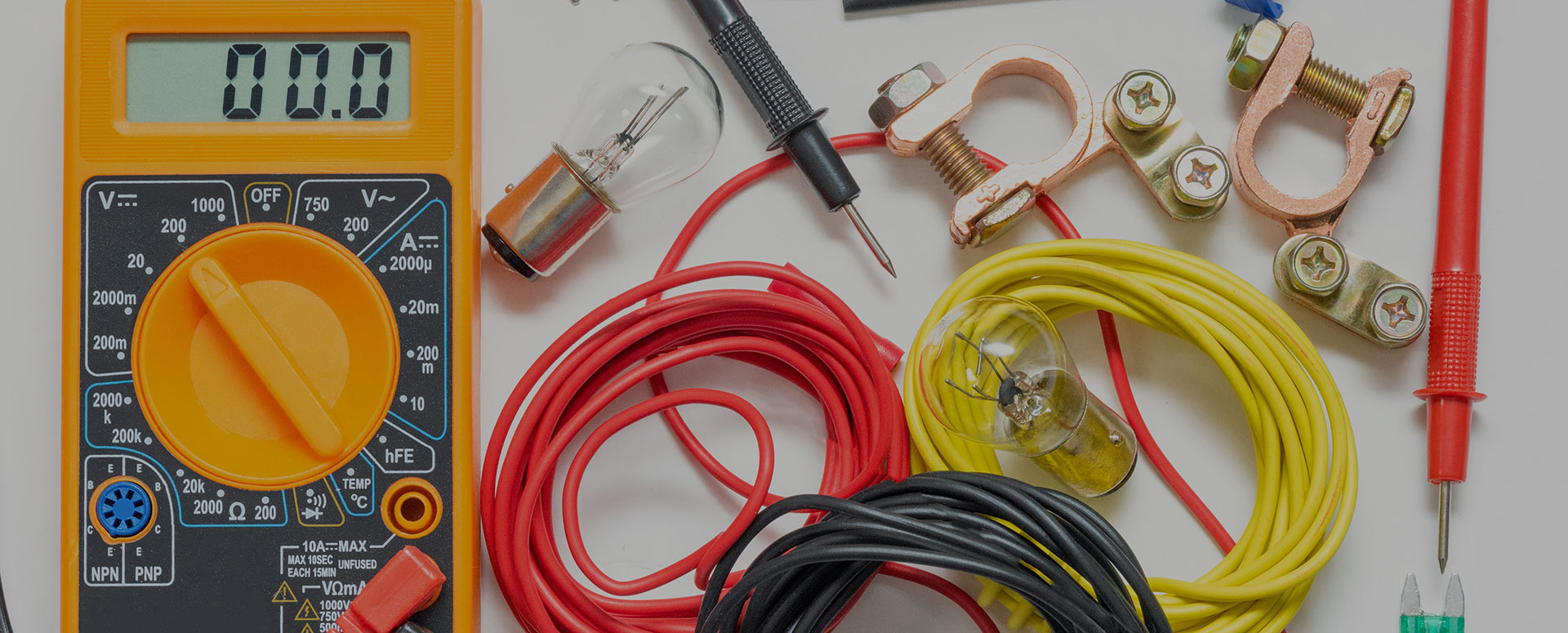 an image showing car accessories like cables, test equipment, and bolts