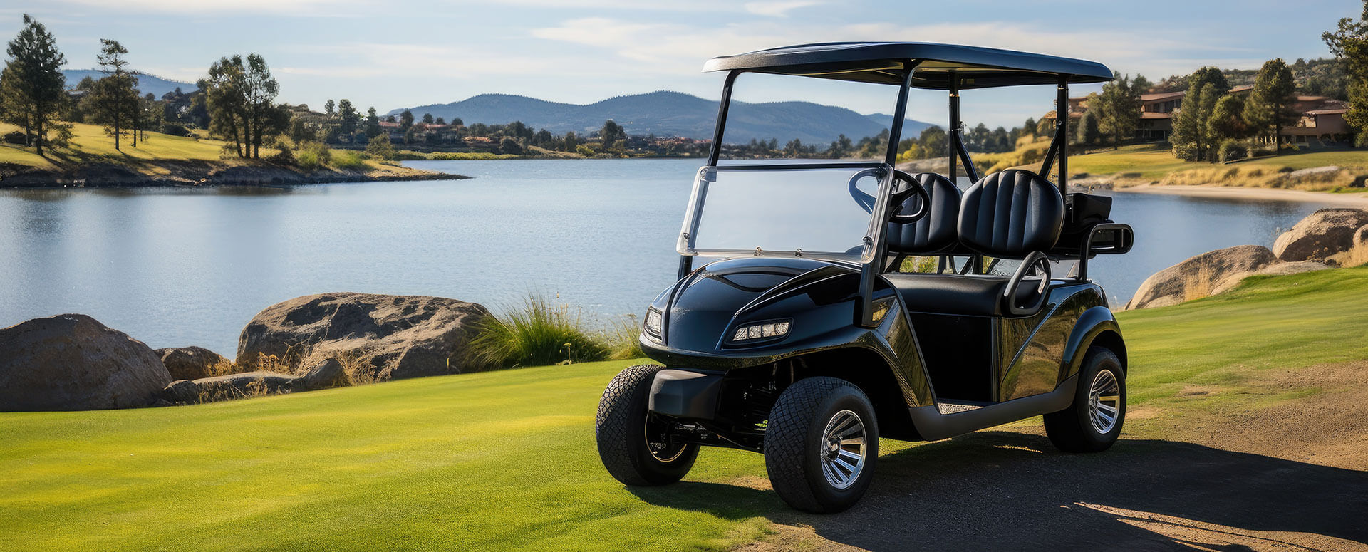 an image of a black golf cart on a course with a lake behind it