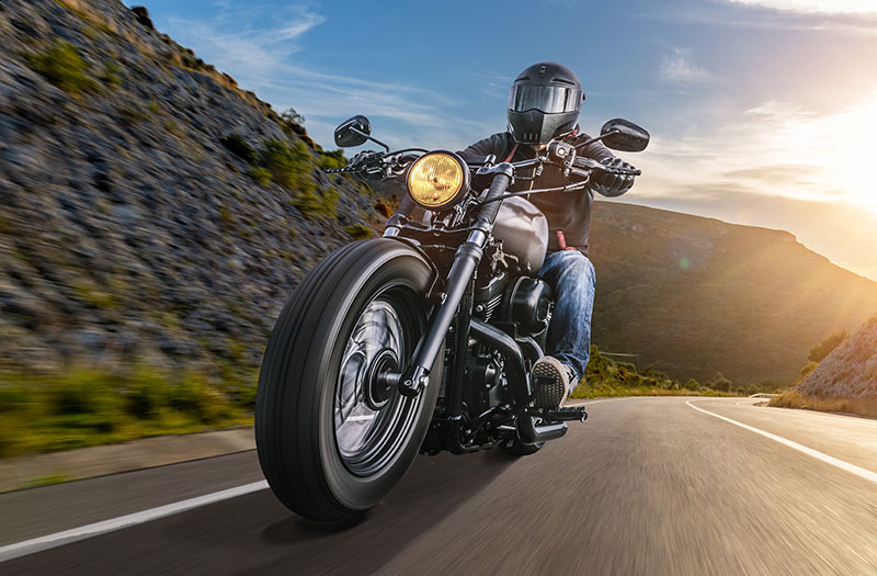 an image of a motorcycle rider on a mountain road