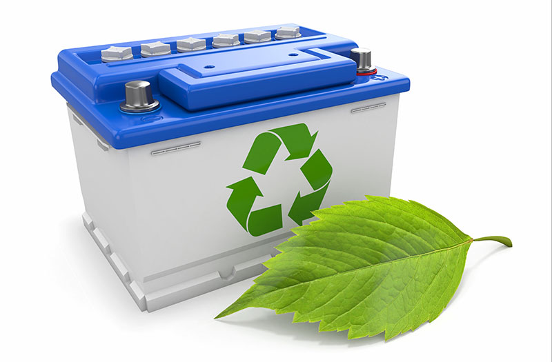 an image showing a battery with a green recycling sign on it, with a leaf in front