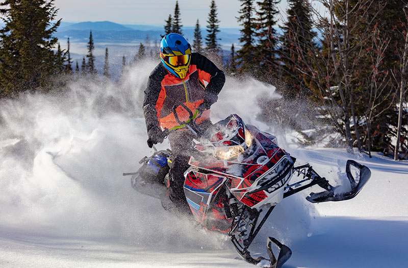 an image of a snowmobile rider taking a sharp turn