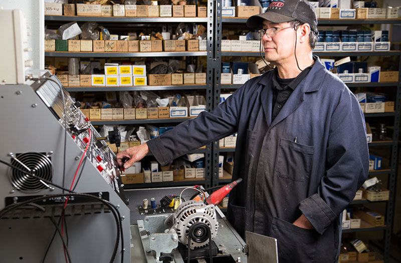 an image of a technician in front of a battery testing machine