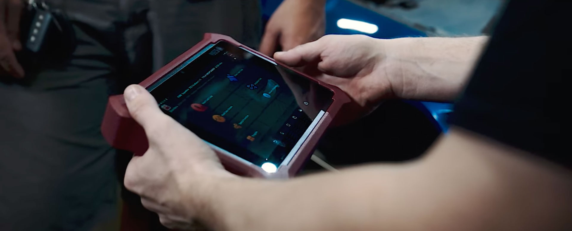 A technician uses a device to perform diagnostics on a battery.