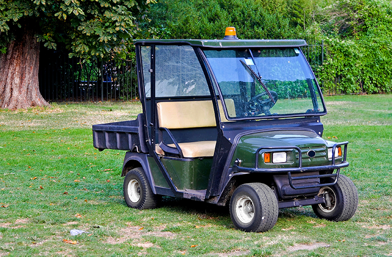 A UTV parked on a lawn.