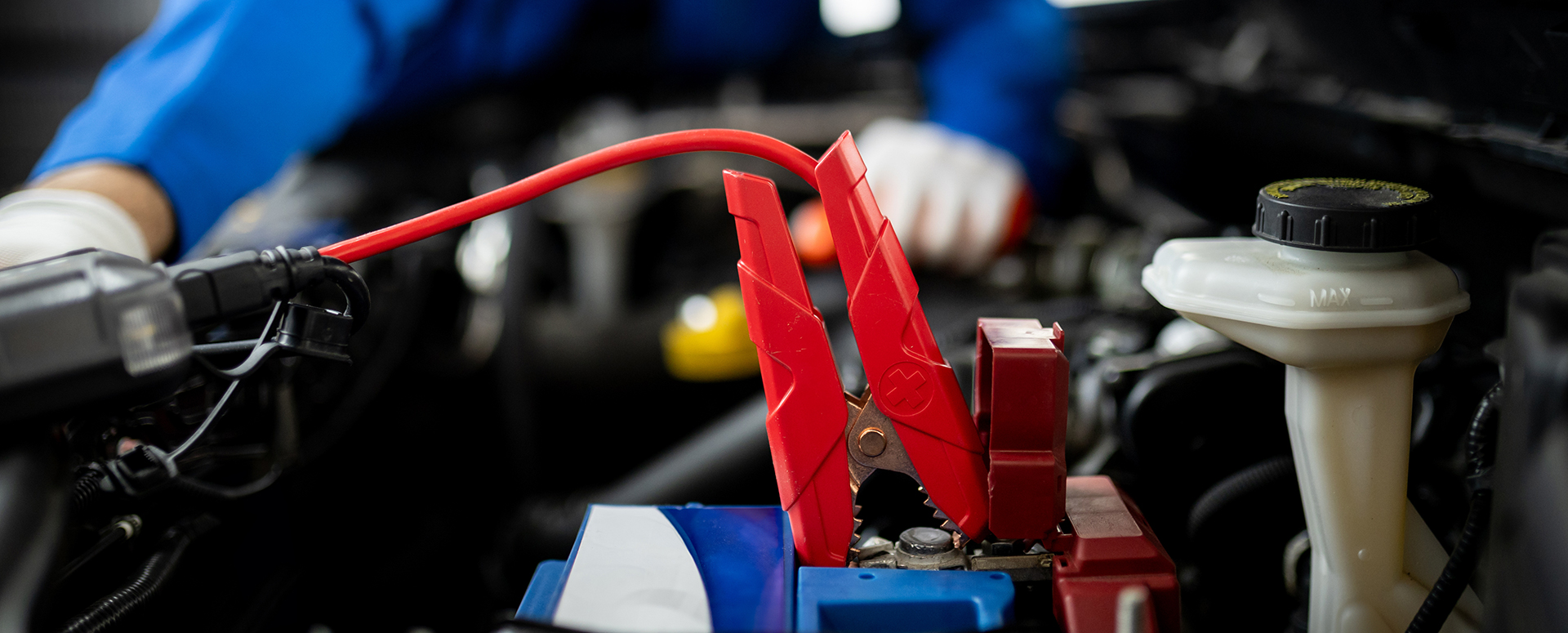 A custom cable clamps onto a positive battery terminal.
