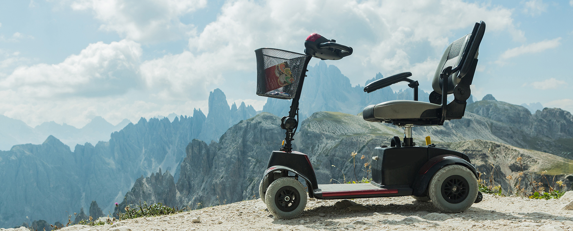 A mobility scooter overlooking a mountainous landscape.